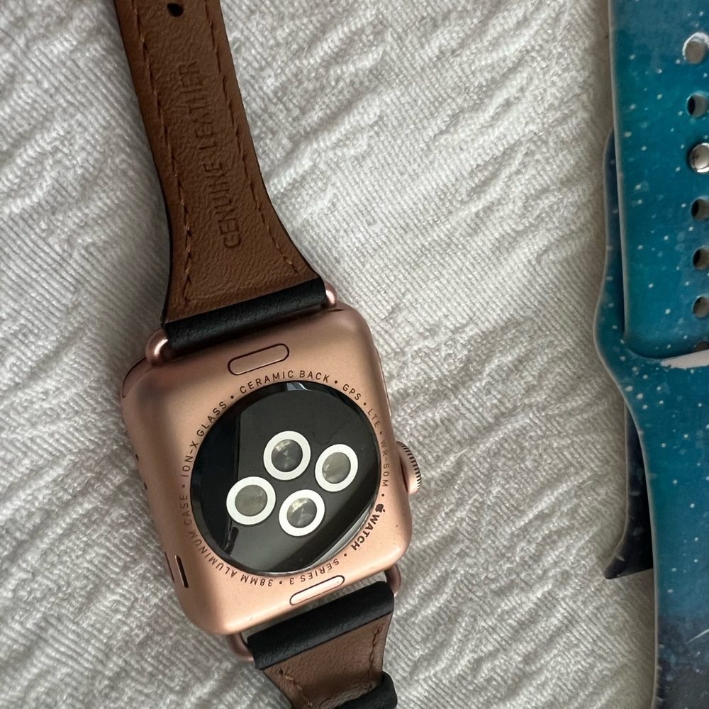 Series 3 Apple Watch and 3 Apple Watch bands. 1 leather and 2 colorful.